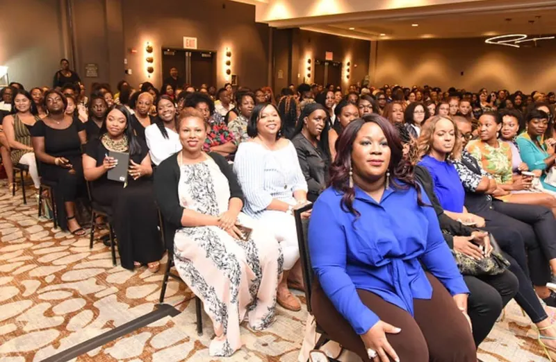 A full room of women gathered in community