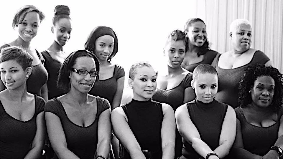 Ten women of the House of Source standing together in a black and white portrait
