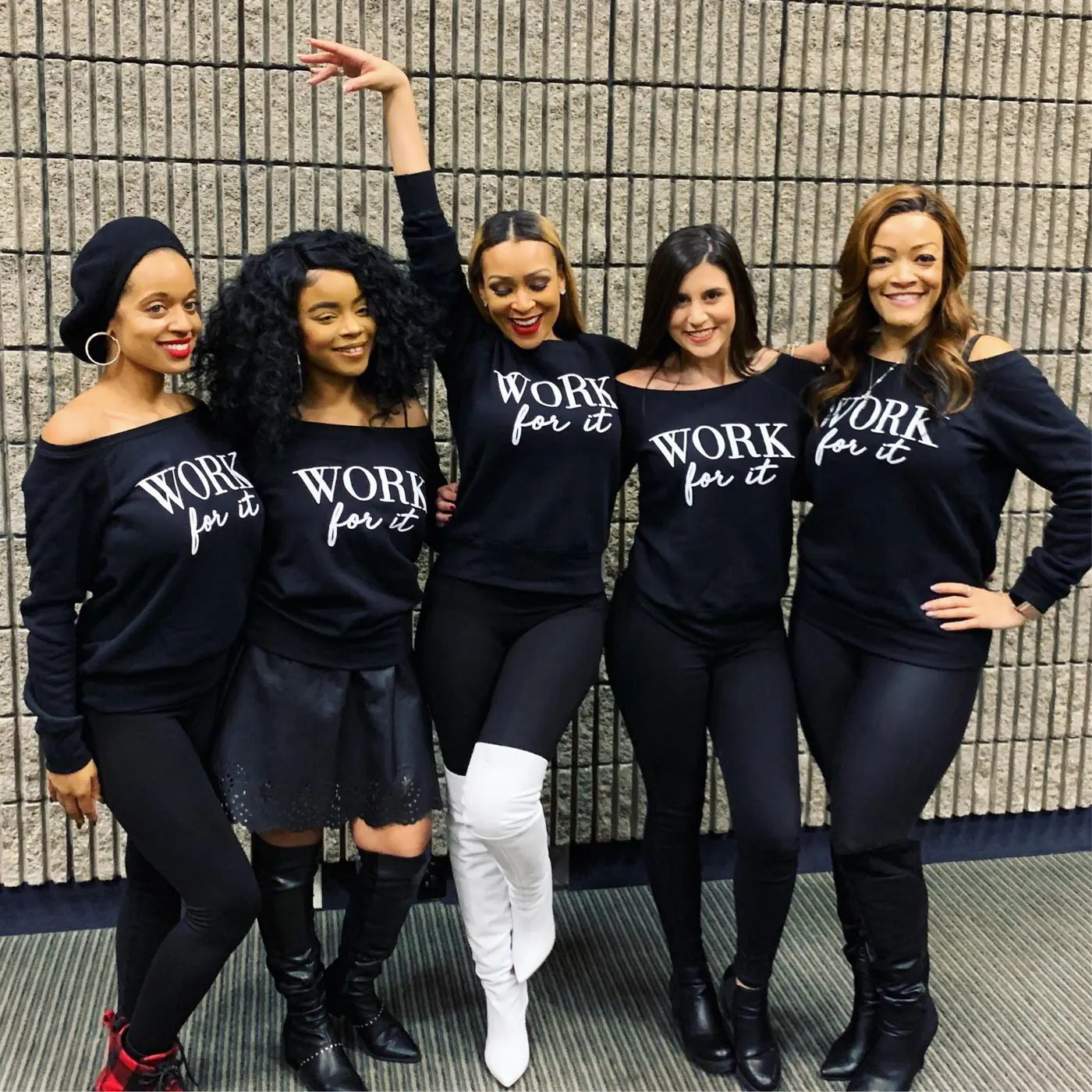 Five women of the House of Source standing shoulder to shoulder wearing matching WORK for it sweatshirts